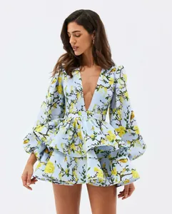 Detailed view of elegant floral puff sleeve dress with deep V-neck and tiered skirt