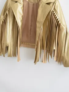Close-up of stylish metallic gold faux leather jacket featuring long fringe tassel details
