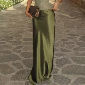 Close-up detail of an elegant olive green satin maxi skirt and lace corset outfit set