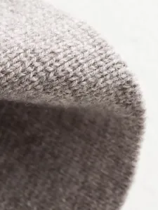 Macro detail of high-quality grey knitted fabric texture on a women's blazer jacket