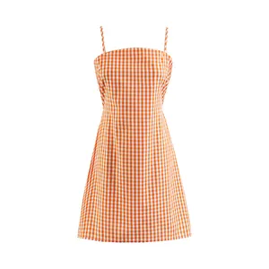 Close-up view of an orange gingham check sleeveless A-line dress with thin straps.