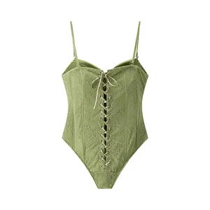 Close-up of green lace corset bodysuit with lace-up front and spaghetti straps