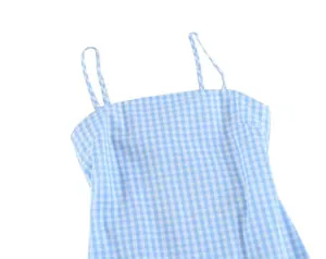 Detailed macro view of the light blue gingham checkered fabric on a summer camisole dress