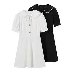 White and black short sleeve dresses with detachable Peter Pan collars and bow details