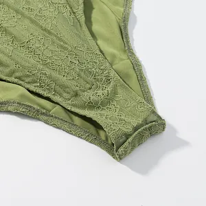 Detailed view of green floral lace and sheer mesh fabric on a stylish corset set piece