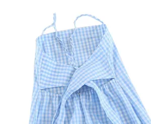 Detail view of the back of a blue and white gingham dress featuring crisscross straps
