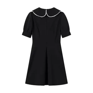 Back view of black dress with a white lace-trimmed detachable Peter Pan collar detail
