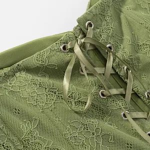 Macro view of olive green floral lace corset top with elegant satin ribbon lacing details.