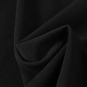 Macro view of high-quality black crepe fabric texture for elegant women's dress