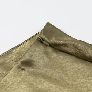 Close-up detail showing the hidden side zipper on premium olive green satin skirt fabric