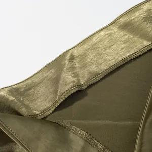 Close-up detail of high-quality olive green satin fabric showing fine stitching