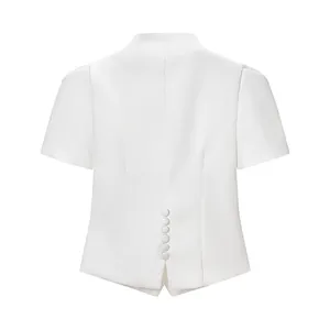Detail view showing the back row of buttons on the white short-sleeved tailored top.