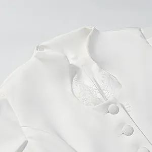 Close-up of elegant white Little Fragrant style top with lace trim and covered buttons