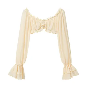 Close-up of a sexy light yellow ruffled off-shoulder crop top with elegant bell sleeves