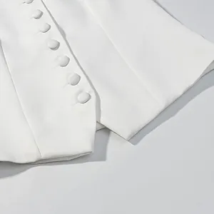 Macro view of white elegant Chanel style vest featuring exquisite fabric-covered buttons detail