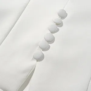 Detail view of white chic short sleeve top with fabric-covered buttons and fine texture