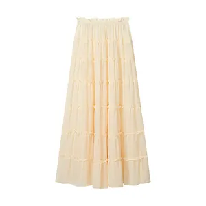 Close-up detail of a cream-colored tiered maxi cake skirt with ruffled elastic waistband