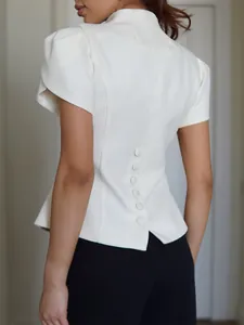 Back view of a white slim-fit short-sleeved peplum top with elegant covered buttons