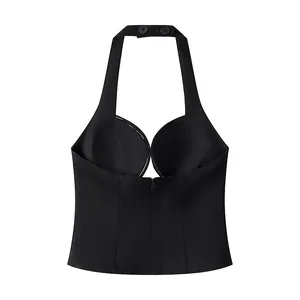 Detailed view of black halter neck top with deep V neckline and back zipper