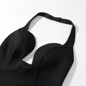 Detailed close-up view of a black halter neck crop top featuring a deep V-neckline design