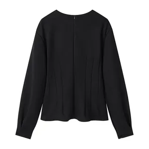 Detailed view of black long-sleeve top with waist-cinching pleats and back zipper