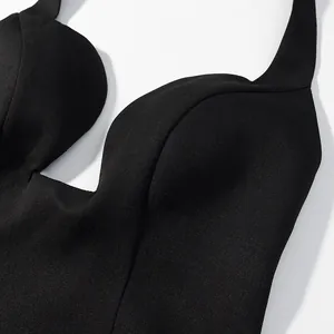 Close-up view of a black halter neck top featuring deep V neckline and textured fabric.