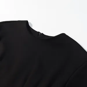 Close-up detail of a round neck black top featuring a secure back zipper closure.