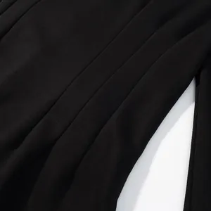 Macro view of the refined pleated fabric details on these black wide-leg trousers