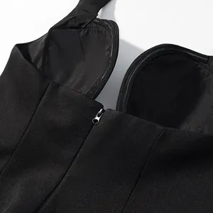 Detail shot of a black halter crop top featuring a deep V-neckline and front zipper closure