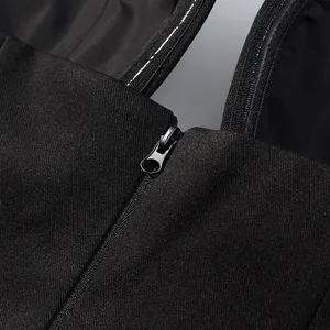 Detail of back zipper closure on a black deep V-neck halter crop top for women