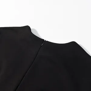Detail view of back invisible zipper on black round neck long sleeve wide leg jumpsuit