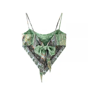 Back view of paisley print camisole featuring a large green bow and irregular hem detail