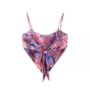 Detail of tie-dye camisole featuring adjustable straps and a back-tie bow knot.
