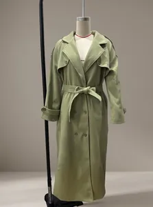 Detailed view of a green long wool coat with large lapels shown on a mannequin.