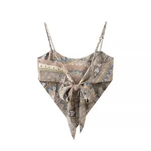 Detailed view of bohemian paisley print camisole top featuring a large adjustable front bow tie