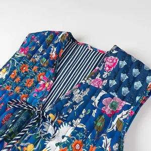 Detailed close-up of quilted floral vest featuring striped lining and front tie cord