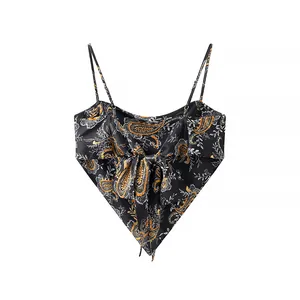 Close-up showing the intricate paisley print and bow tie detail on a black camisole top