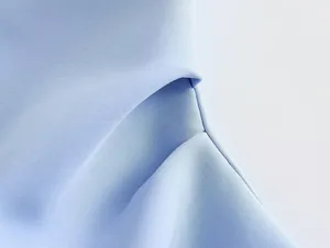 Vue détaillée d'un top bustier bleu clair plissé montrant la texture fine du tissu
