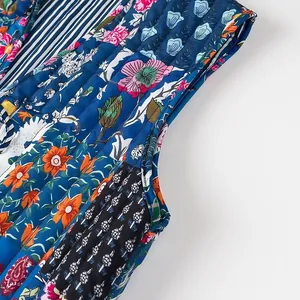 Close-up of vibrant floral print and quilted texture on a women's fashion vest.