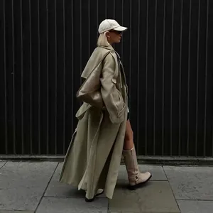 Street style macro view of long wool trench coat with large lapel and waist belt