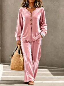 Detailed view of women's pink velvet lounge set featuring V-neck button top and soft fabric