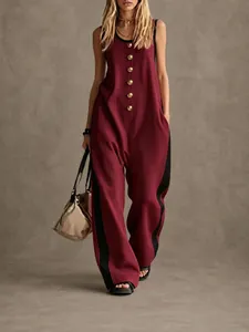 Detail view of burgundy sleeveless wide-leg jumpsuit with gold buttons and black side stripes