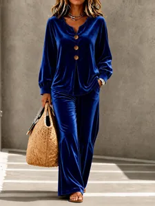 Detailed view of the royal blue velvet lounge set featuring a button V-neck top and long pants