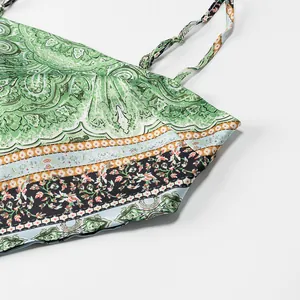 Detailed close-up showing the green paisley print and delicate floral hem of the summer camisole