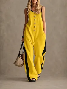 Detail of fashionable color-block sleeveless jumpsuit featuring creative gold buttons.
