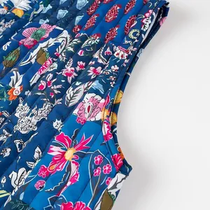 Macro view of a vibrant floral print quilted vest showing fine stitching details
