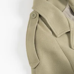 Detailed close-up view of khaki wool coat shoulder epaulette and lapel collar texture