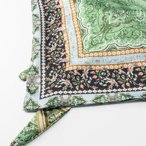 Detailed close-up showing the intricate paisley print on a green vacation style camisole