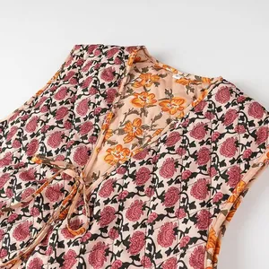 Detailed close-up showing the floral print and quilted texture of a V-neck tie-front vest