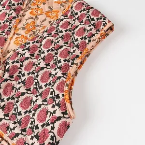 Detailed view of vintage floral print and stitching on a quilted V-neck sleeveless vest